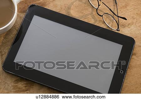 Stock Photograph - Studio shot of digital tablet on table. Fotosearch