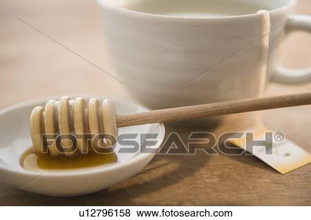 Studio shot of tea cup and honey spoon View Large Photo Image Stock Photo - Studio shot of tea cup and honey spoon. Fotosearch