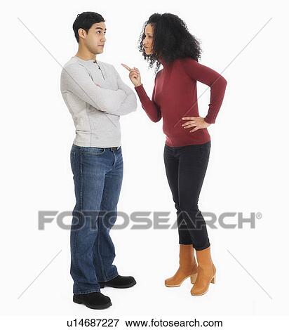 Studio shot of young couple arguing View Large Photo Image Stock Photo - Studio shot of young couple arguing. Fotosearch