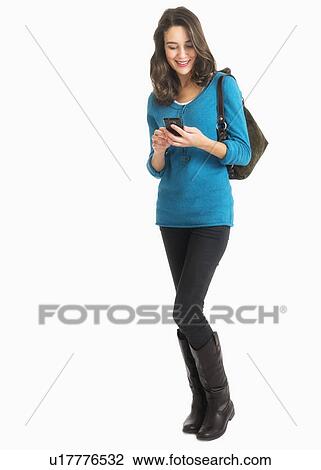 Stock Image - Studio shot of young woman text messaging. Fotosearch