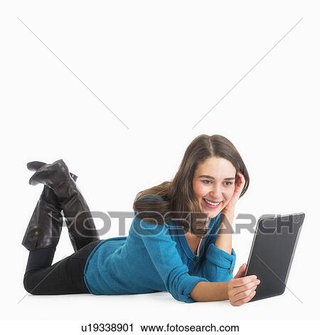 Studio shot of young woman using laptop View Large Photo Image Stock Image - Studio shot of young woman using laptop. Fotosearch
