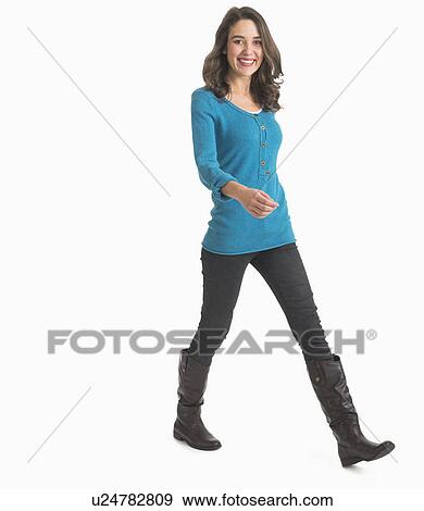 Studio shot of young woman walking View Large Photo Image Stock Photo - Studio shot of young woman walking. Fotosearch