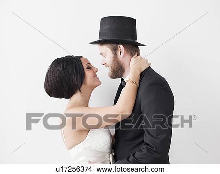 Studio Shot portrait of bride and groom smiling face to face View Large Photo Image Picture - Studio Shot portrait of bride and groom smiling face to face. Fotosearch