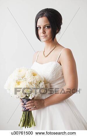 Studio Shot portrait of bride holding bouquet View Large Photo Image Stock Image - Studio Shot portrait of bride holding bouquet. Fotosearch