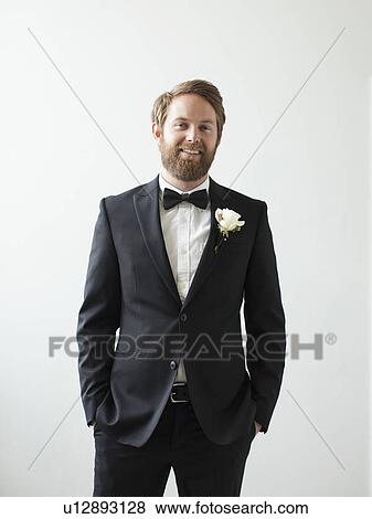 Studio Shot portrait of smiling groom with hands in pockets View Large Photo Image Stock Photo - Studio Shot portrait of smiling groom with hands in pockets. Fotosearch