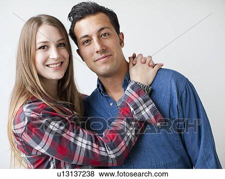 Stock Photo - Studio Shot portrait of young couple. Fotosearch