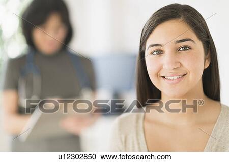 Teenage girl (16-17) in doctor's office View Large Photo Image Stock Image - Teenage girl (16-17) in doctor's office. Fotosearch