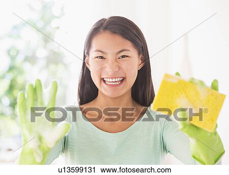 Teenage girl wearing rubber gloves and holding sponge View Large Photo Image Stock Image - Teenage girl wearing rubber gloves and holding sponge. Fotosearch