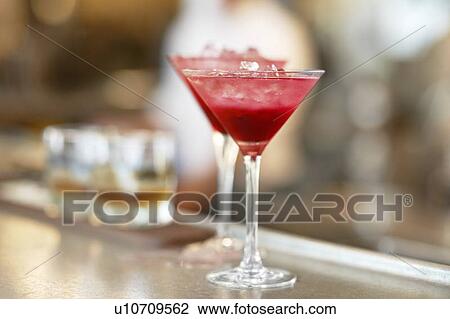 Two martini glasses standing on bar counter View Large Photo Image Stock Image - Two martini glasses standing on bar counter. Fotosearch