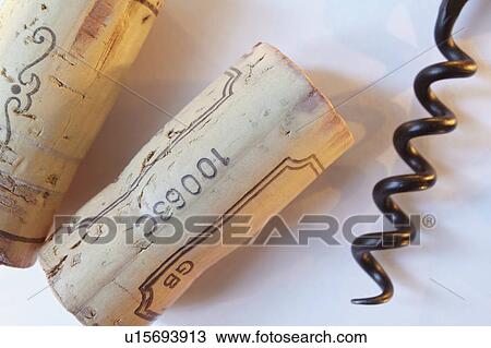 Stock Image - Two wine corks and corkscrew. Fotosearch