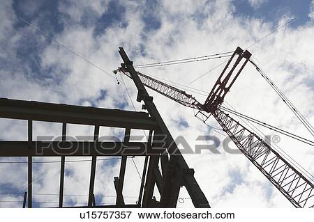 Stock Photo - Upward view of crane and construction. Fotosearch