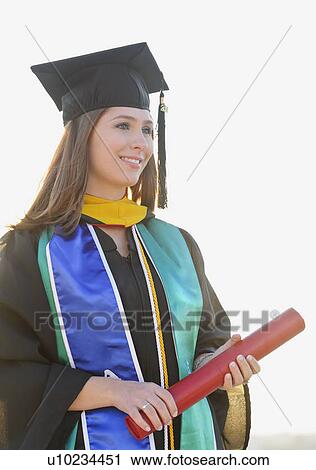 Stock Image - View of graduate student holding diploma. Fotosearch