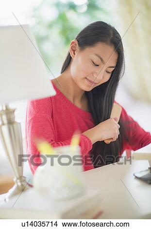 View of teenage girl ( 16-17 years) brushing hair View Large Photo Image Picture - View of teenage girl ( 16-17 years) brushing hair. Fotosearch