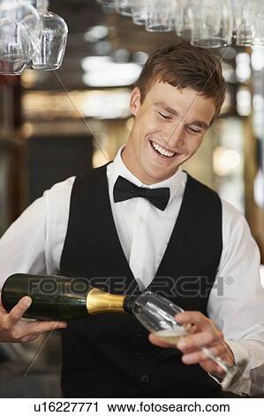 Waiter pouring champagne into champagne flute View Large Photo Image Stock Image - Waiter pouring champagne into champagne flute. Fotosearch