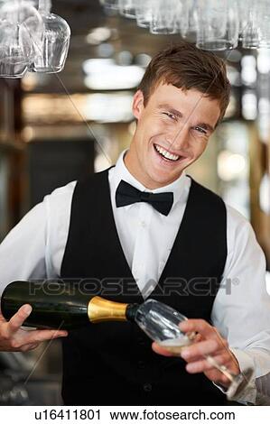 Waiter pouring champagne into champagne flute View Large Photo Image Stock Image - Waiter pouring champagne into champagne flute. Fotosearch