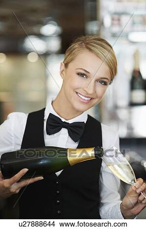 Waitress pouring champagne into champagne flute View Large Photo Image Picture - Waitress pouring champagne into champagne flute. Fotosearch
