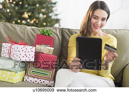 Woman buying christmas gift via internet View Large Photo Image Stock Photo - Woman buying christmas gift via internet. Fotosearch