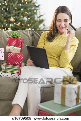Woman buying christmas gift via internet View Large Photo Image Stock Photo - Woman buying christmas gift via internet. Fotosearch