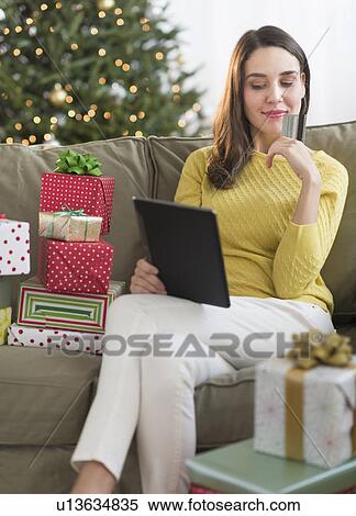 Woman buying christmas gift via internet View Large Photo Image Stock Photography - Woman buying christmas gift via internet. Fotosearch