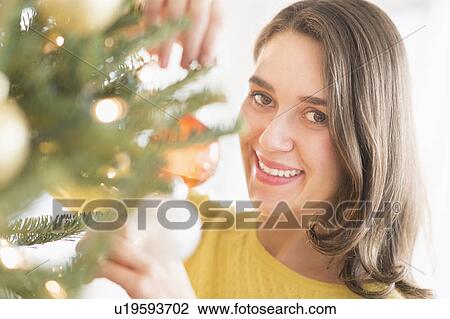 Woman decorating christmas tree View Large Photo Image Stock Image - Woman decorating christmas tree. Fotosearch