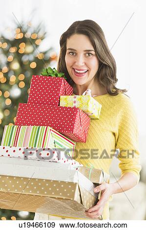 Woman holding christmas gifts View Large Photo Image Stock Photo - Woman holding christmas gifts. Fotosearch
