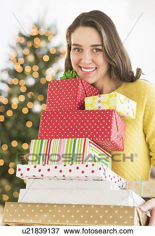 Woman holding christmas gifts View Large Photo Image Stock Photo - Woman holding christmas gifts. Fotosearch
