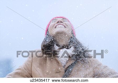 Stock Photo - Woman in snowfall. Fotosearch