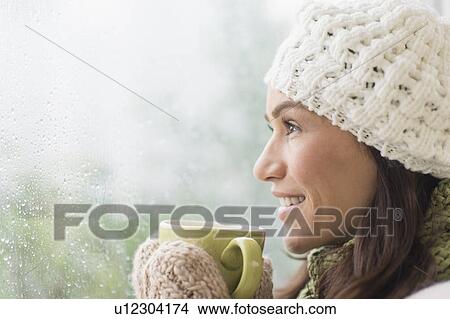 Woman in warm clothes holding mug View Large Photo Image Picture - Woman in warm clothes holding mug. Fotosearch