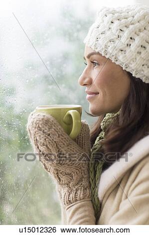 Woman in warm clothes holding mug View Large Photo Image Stock Photograph - Woman in warm clothes holding mug. Fotosearch