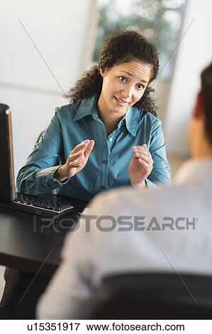 Woman interviewing man at desk View Large Photo Image Stock Photo - Woman interviewing man at desk. Fotosearch
