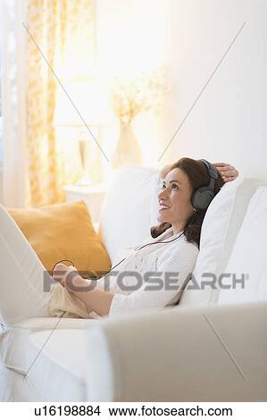Woman listening to music at home View Large Photo Image Picture - Woman listening to music at home. Fotosearch