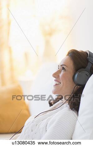 Woman listening to music at home View Large Photo Image Stock Photography - Woman listening to music at home. Fotosearch