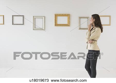 Woman looking at blank pictures in art gallery View Large Photo Image Stock Image - Woman looking at blank pictures in art gallery. Fotosearch