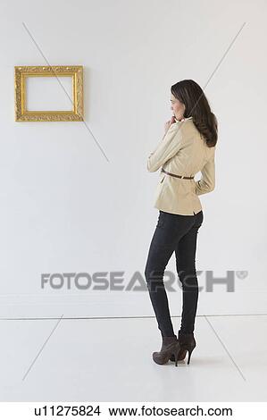 Woman looking at picture in art gallery View Large Photo Image Picture - Woman looking at picture in art gallery. Fotosearch