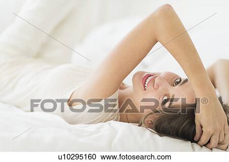 Stock Image - Woman lying in bed . Fotosearch