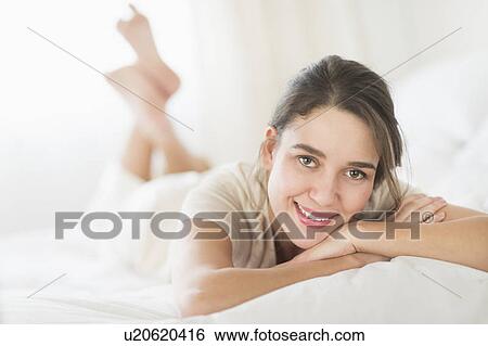 Woman lying in bed View Large Photo Image Stock Photograph - Woman lying in bed . Fotosearch