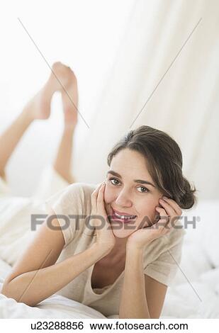 Woman lying in bed View Large Photo Image Stock Photograph - Woman lying in bed . Fotosearch