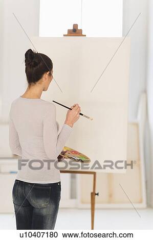 Woman painting at easel View Large Photo Image Stock Image - Woman painting at easel. Fotosearch