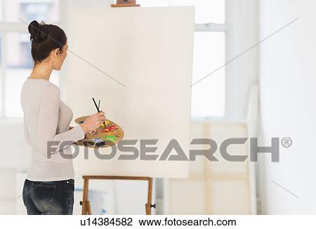 Woman painting at easel View Large Photo Image Stock Image - Woman painting at easel. Fotosearch