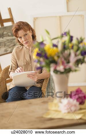 Woman sketching flowers View Large Photo Image Stock Image - Woman sketching flowers. Fotosearch