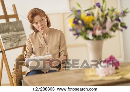 Woman sketching flowers View Large Photo Image Stock Image - Woman sketching flowers. Fotosearch