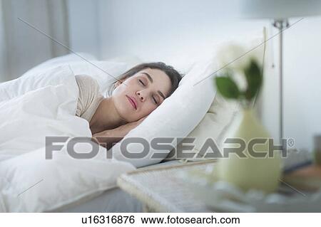 Woman sleeping in bed View Large Photo Image Stock Photograph - Woman sleeping in bed. Fotosearch