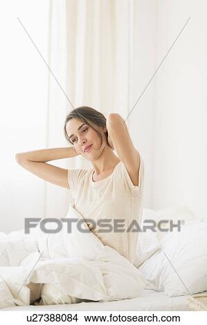 Woman stretching on bed View Large Photo Image Picture - Woman stretching on bed. Fotosearch