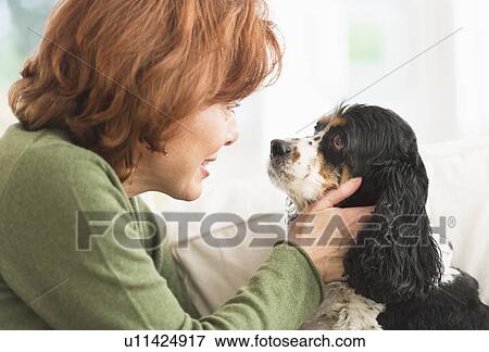Woman stroking dog View Large Photo Image Stock Photo - Woman stroking dog. Fotosearch