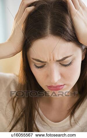 Stock Photo - Woman suffering from headache. Fotosearch
