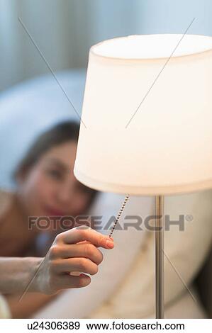Woman turning off lamp View Large Photo Image Stock Photo - Woman turning off lamp. Fotosearch