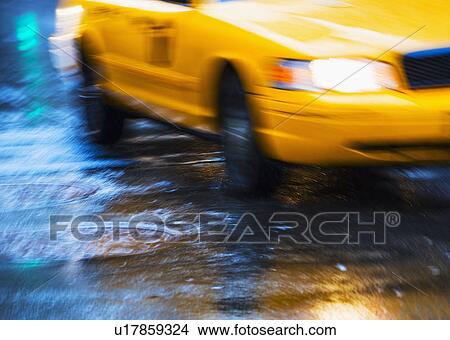 Picture - Yellow cab in blurred motion. Fotosearch