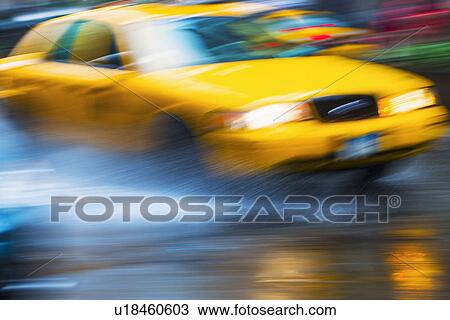 Stock Image - Yellow cab in blurred motion. Fotosearch