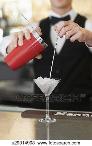 Young bartender pouring cocktail View Large Photo Image Stock Photo - Young bartender pouring cocktail . Fotosearch