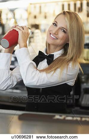 Young female bartender using cocktail shaker View Large Photo Image Stock Image - Young female bartender using cocktail shaker. Fotosearch